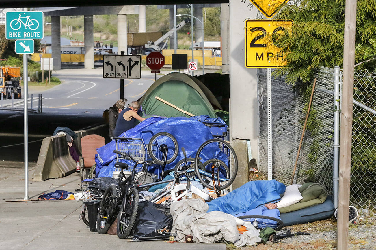 Previous Smith Ave campers have relocated to across the  'no-sit, no-lie' ordinance boundary and set up on Hewitt at the US 2 entrance in Everett. (Kevin Clark / The Herald)