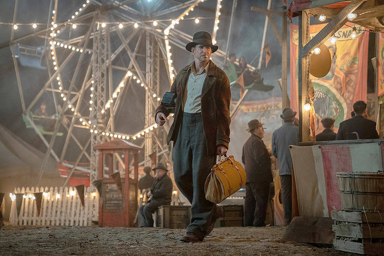 “Nightmare Alley,” set in the 1930s, focuses on a more-or-less amoral grifter (Bradley Cooper) who arrives at a low-rent carnival. (20th Century Studios)