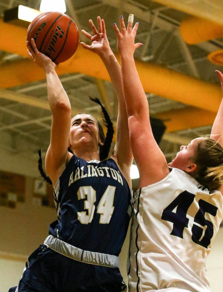 Arlington’s Jenna Villa attempts a shot over Edmonds-Woodway’s Halle Waram Thursday evening at Edmonds-Woodway High School on January 16, 2020. (Kevin Clark / The Herald)
