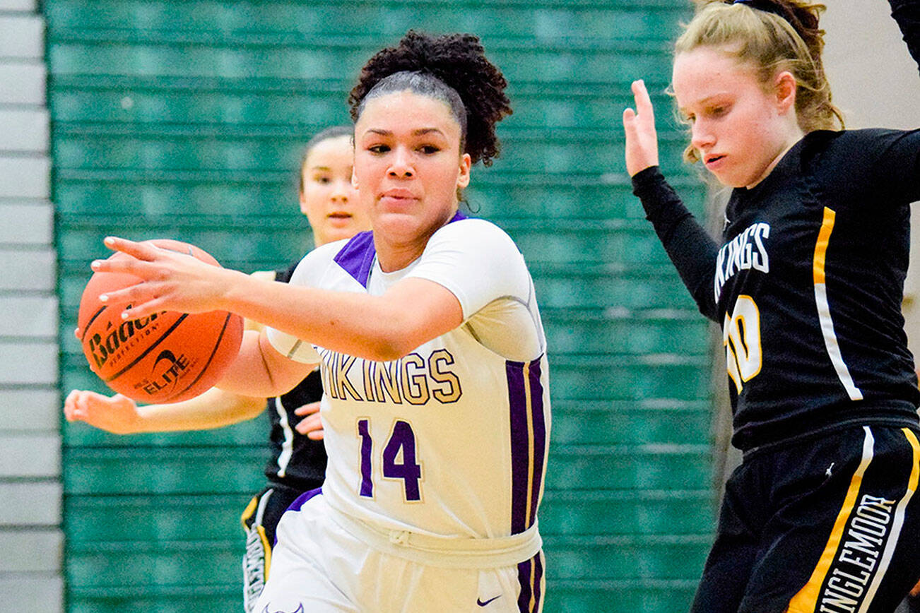 Lake Stevens' Baylor Thomas dribbles past an Inglemoor defender in a winner-to-state, loser-out game on Thursday, Feb. 20, 2020, at Jackson High School in Mill Creek. (Katie Webber / The Herald)