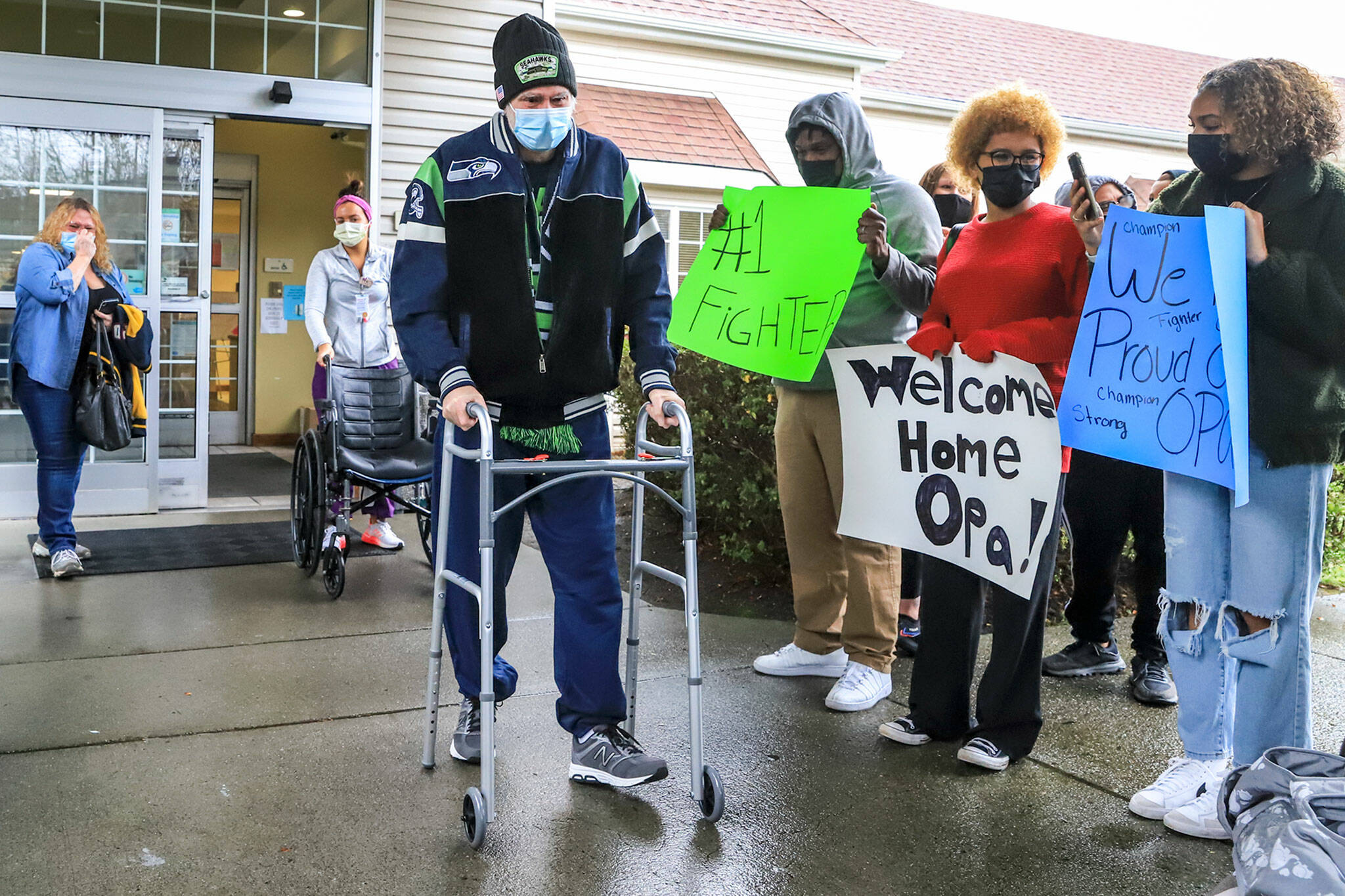 Gunard Hulskamp is celebrated by friends and family as he exits the Everett Center on Dec. 18, 2021 after battling COVID-19 for 236 days. (Kevin Clark / The Herald)