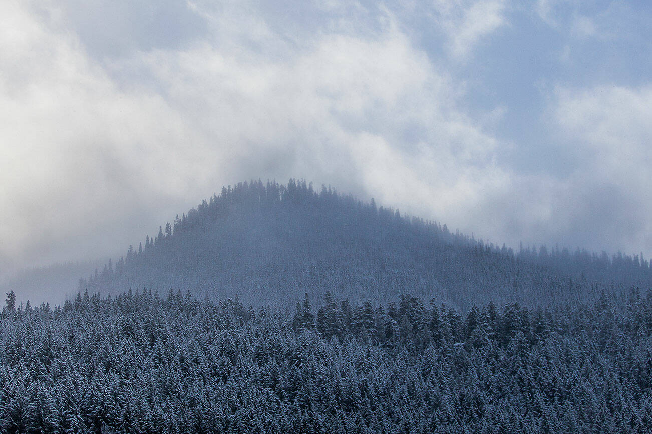 Clouds move through the mountains in Skykomish on Tuesday, Dec. 14, 2021. (Olivia Vanni / The Herald)