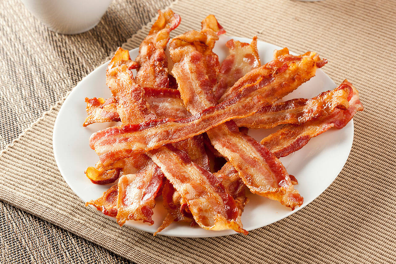 For better results and no greasy splatter on your stove (or you), slow-bake bacon in the oven. (Getty Images)
