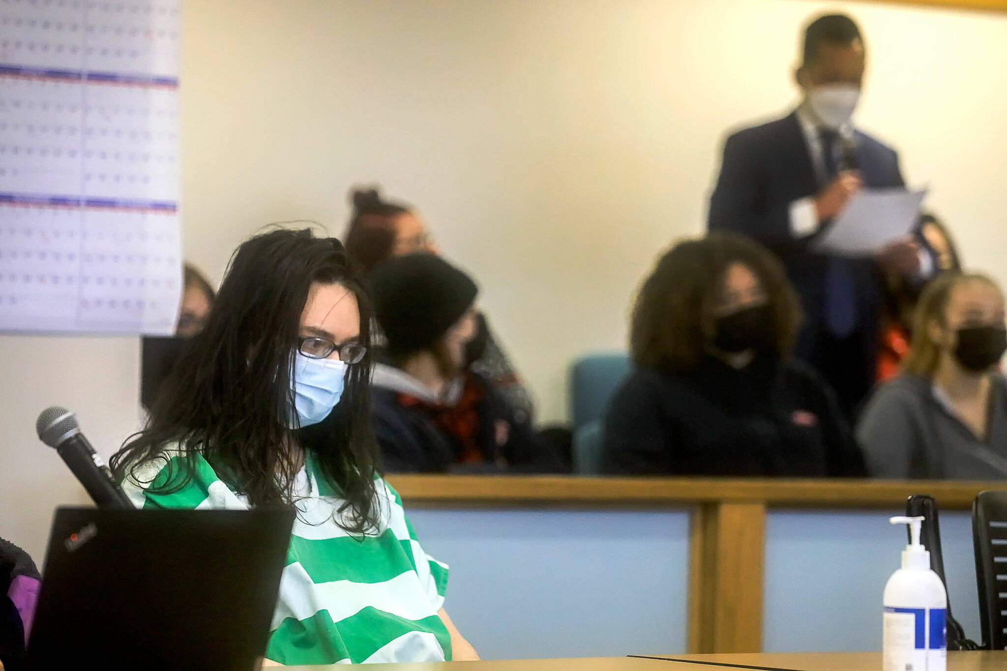 Michealob Johnson listens as his victim’s son addresses the court Tuesday afternoon at the Snohomish County Superior Courthouse in Everett on December 21, 2021. (Kevin Clark / The Herald)