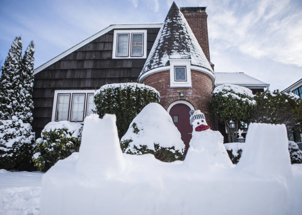 A snow fort created by Sophia Gillette, 10, is visible in front of her home Monday in Everett. (Olivia Vanni / The Herald)
