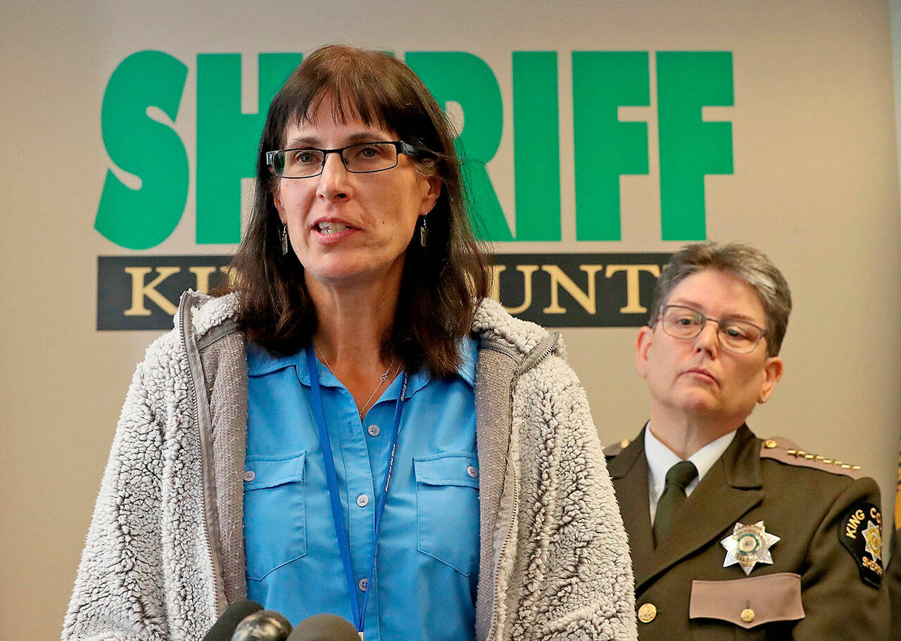 In this 2019 photo, King County Detective Kathleen Decker speaks at a news conference as Sheriff Mitzi G. Johanknecht looks on. Decker, a now-retired 33-year veteran of the King County Sheriff’s Office, made several false statements under oath when she obtained a search warrant in a murder case in 2019, resulting in a man’s false arrest on drug charges, newly unsealed federal court orders show. (Greg Gilbert / The Seattle Times via Associated Press)