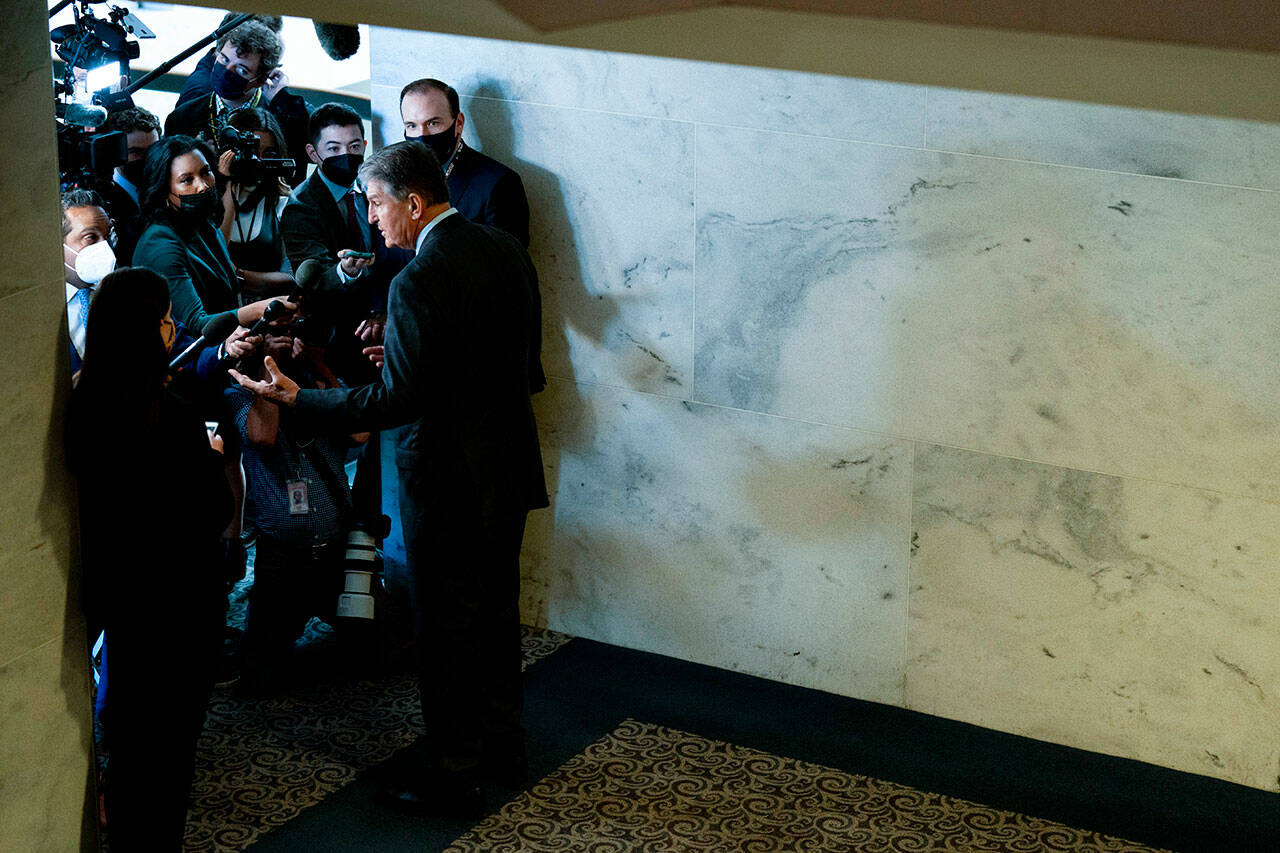 Sen. Joe Manchin, D-W.Va., a key holdout vote on President Joe Biden’s domestic agenda, speaks to reporters on Capitol Hill in Washington, Oct. 27. (Andrew Harnik / Associated Press)