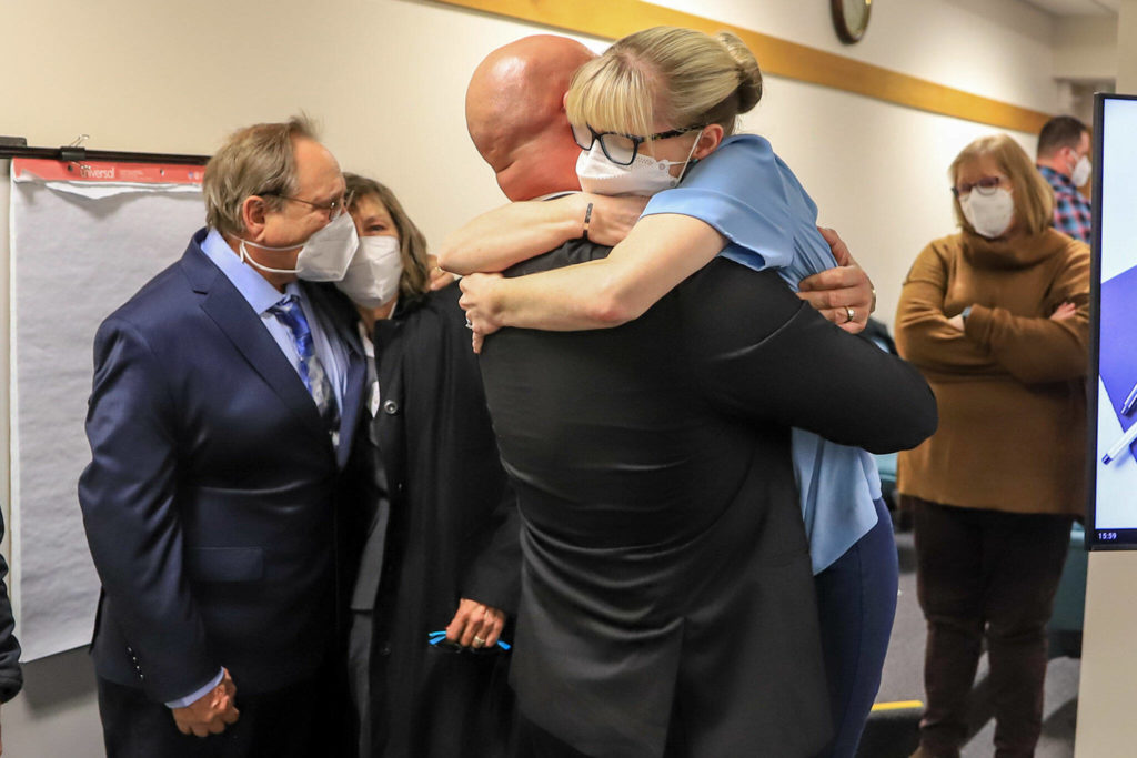 Ryan Leenders (left) and Amber Leenders share a hug after hearing the not guilty verdicts handed down by a jury Thursday afternoon at the Snohomish County Superior Courthouse in Everett. (Kevin Clark / The Herald)
