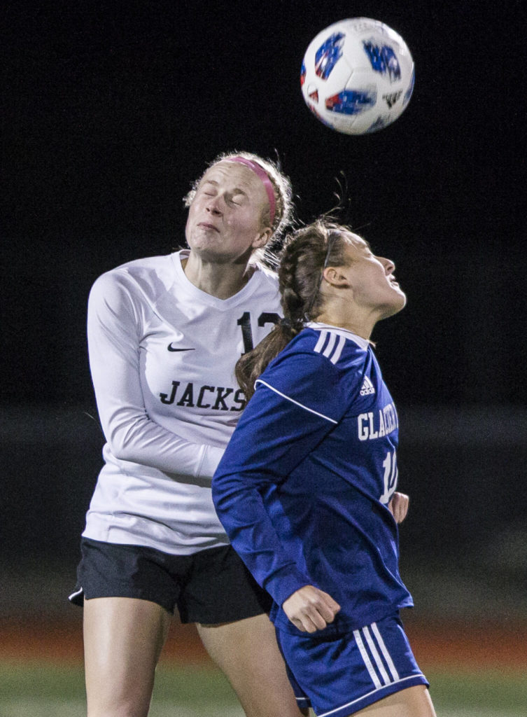 Jackson’s Kate Russell jumps to head the ball during a game at Glacier Peak High School on Oct. 26, 2021 in Snohomish. (Olivia Vanni / The Herald)

