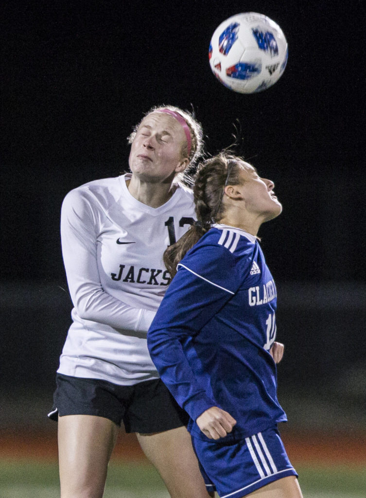 Jackson’s Kate Russell jumps to head the ball during a game at Glacier Peak High School on Oct. 26, 2021 in Snohomish. (Olivia Vanni / The Herald)
