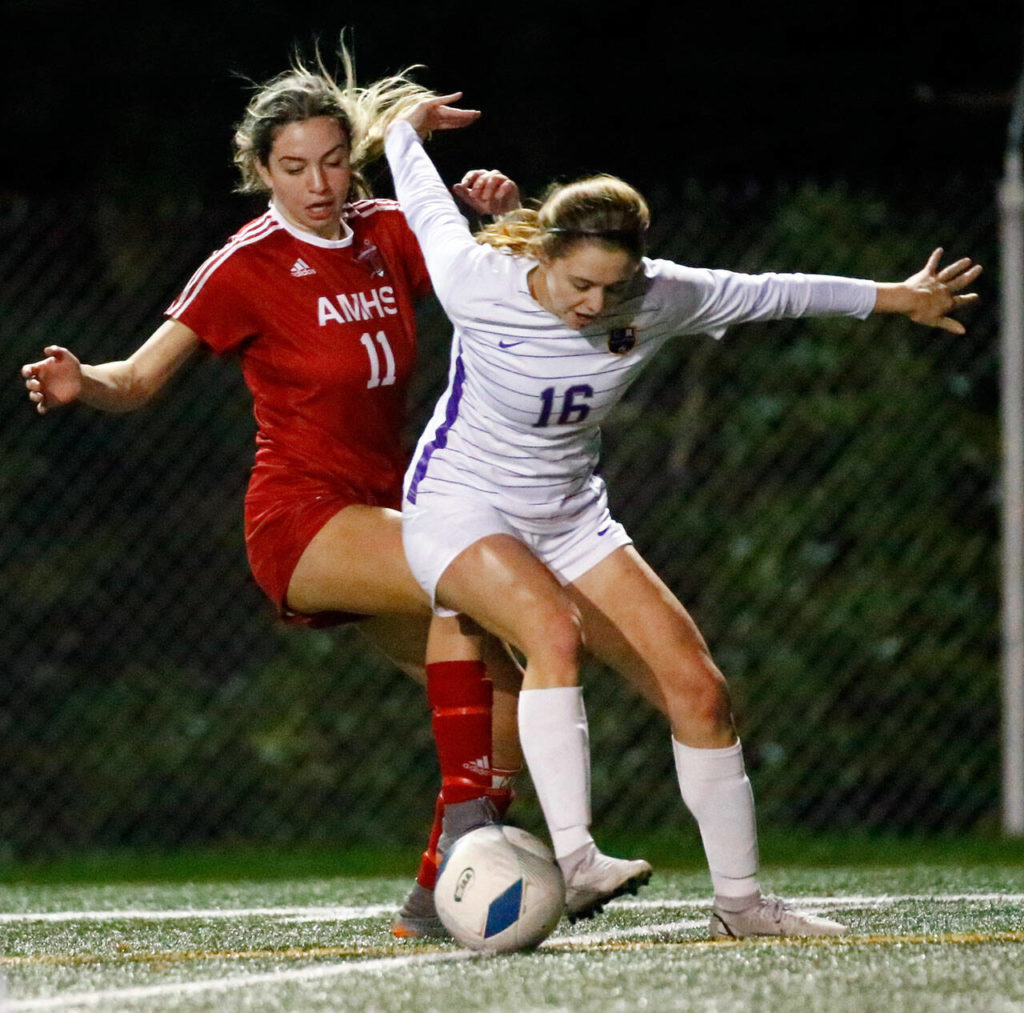 Archbishop Murphy’s Taylor Campbell (left) fights for the ball during a game against Columbia River at Shoreline Stadium on Nov. 19, 2021. (Kevin Clark / The Herald)
