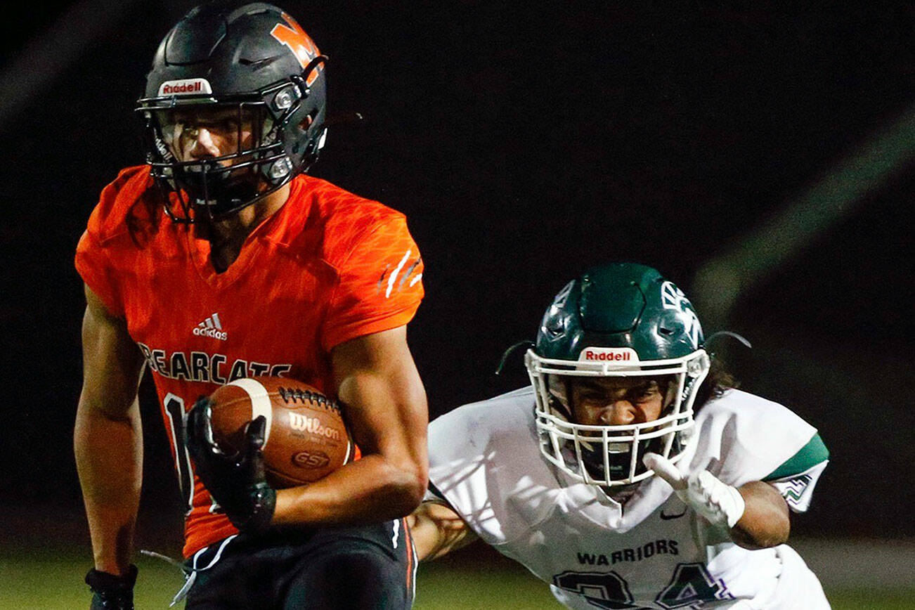 Monroe's Cole Pruett looks for an open lane with Edmonds-Woodway's Nathanuel Marinez closing Friday night at Monroe High School on October 1, 2021.   (Kevin Clark / The Herald)