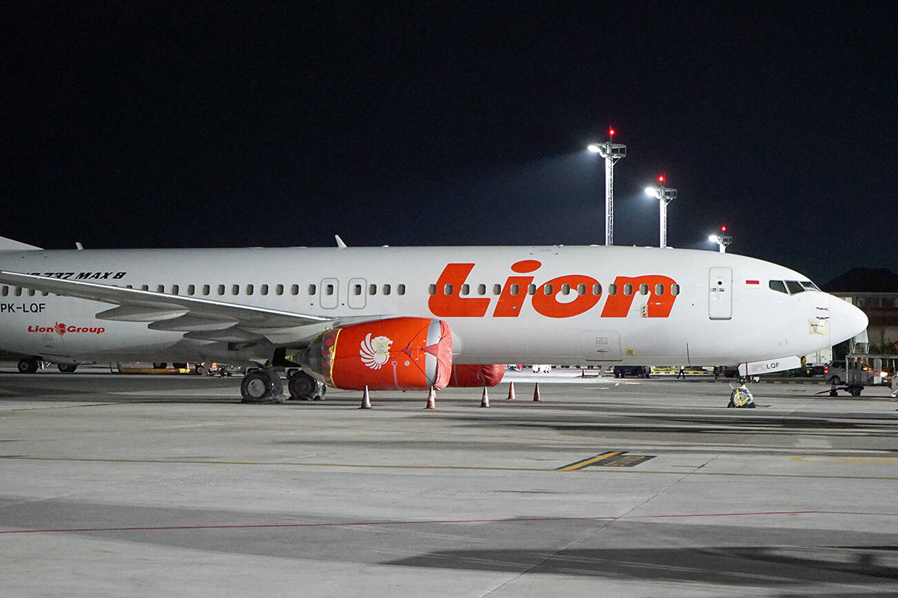 FILE - Lion Air's Boeing 737 Max 8 sits on the tarmac at Ngurah Rai International Airport in Bali, Indonesia, April 13, 2019. Indonesia said Wednesday, Dec. 29, 2021, it is lifting its ban on Boeing’s 737 Max aircraft, three years after one crashed shortly after takeoff, killing all 189 people on board. (AP Photo Nicole Evatt, File)