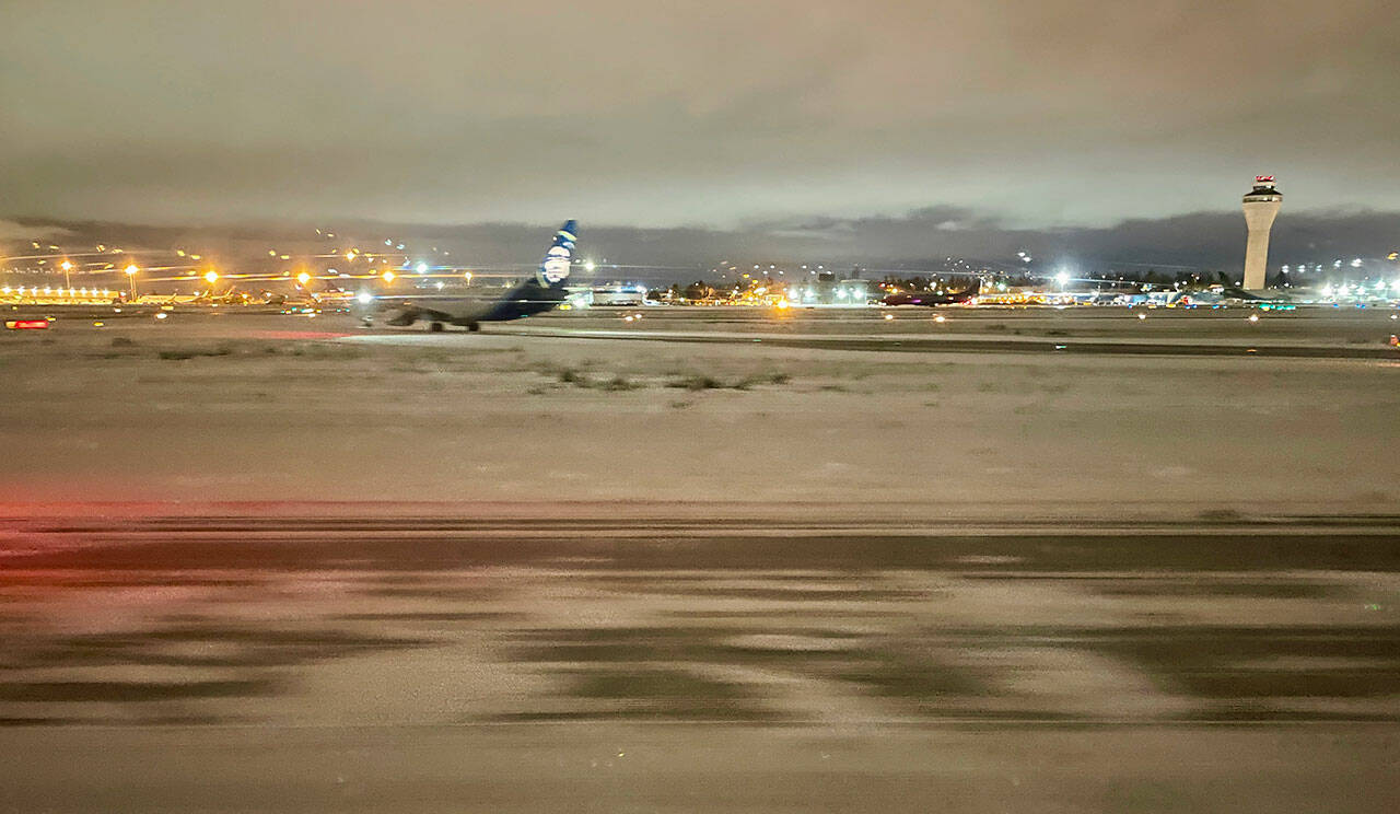 Seattle-Tacoma International Airport in SeaTac on Sunday night, after a day of snowfall. (Chuck Taylor / The Herald)