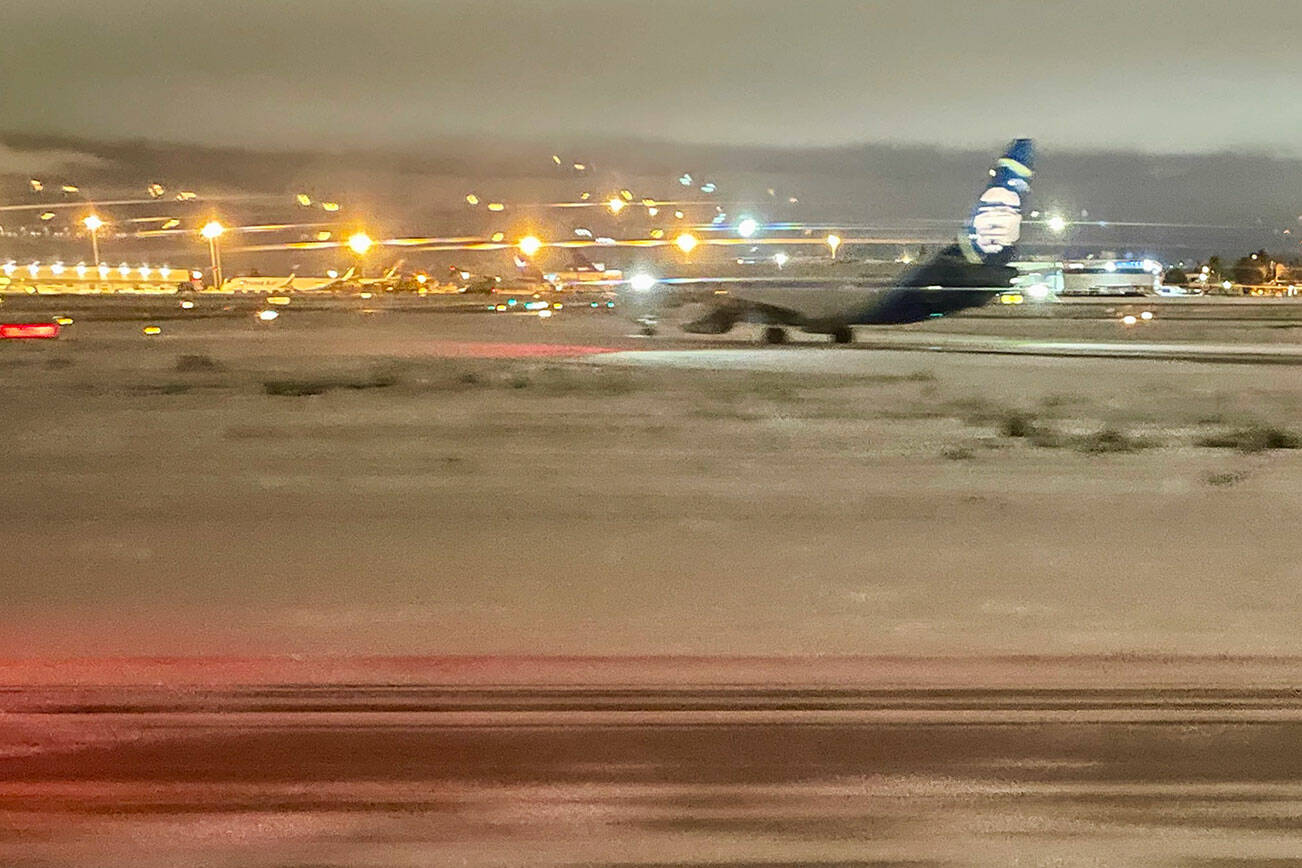 Seattle-Tacoma International Airport in SeaTac on Sunday night, after a day of snowfall. (Chuck Taylor / The Herald) 20211226