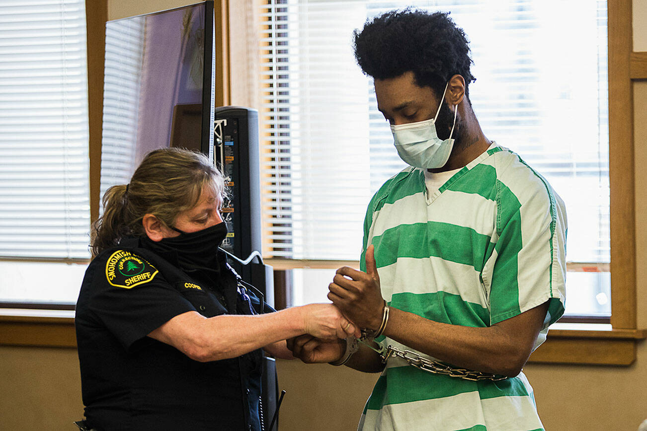 Kevin Lewis is handcuffed after receiving a life sentence in prison for aggravated murder in the first degree on Tuesday, Jan. 4, 2022 in Everett, Washington. (Olivia Vanni / The Herald)