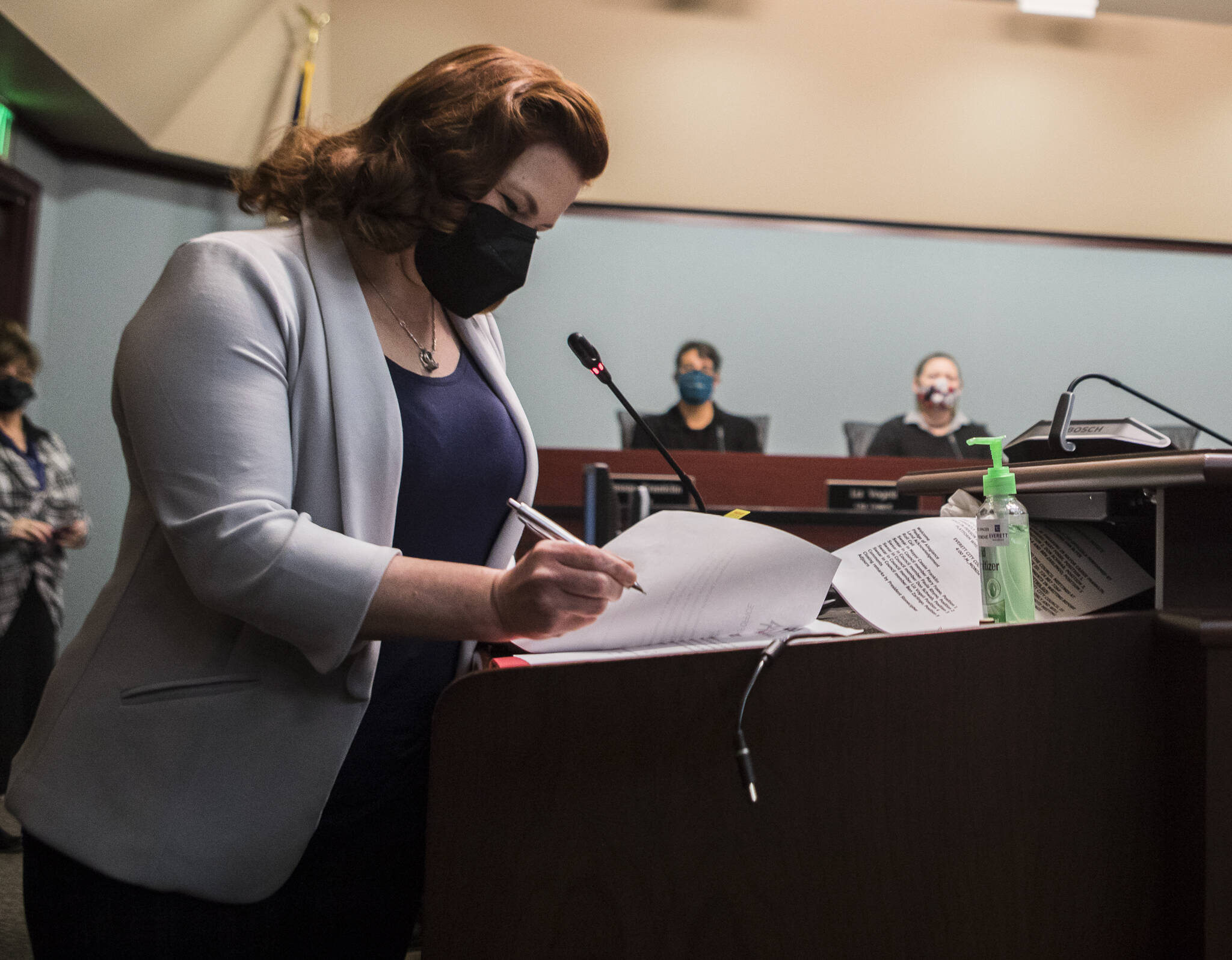 Everett City Councilmember Mary Fosse signs paperwork after being sworn in Monday at Everett City Hall. (Olivia Vanni / The Herald)