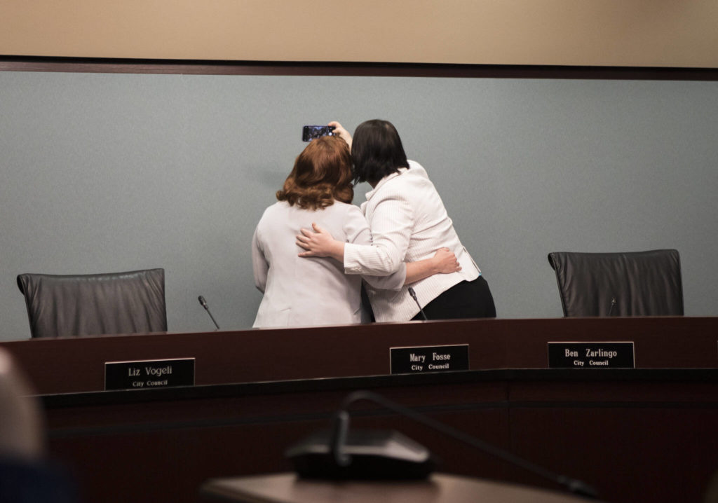 Everett City Councilmembers Mary Fosse and Paula Rhyne take a photograph together after taking their oaths of office Monday in Everett. (Olivia Vanni / The Herald)
