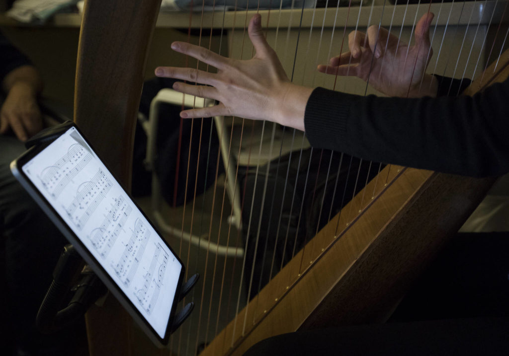 Harpist April Mitchell performs for Shelly Holmgren at Providence Regional Medical Center Everett on Dec. 17, 2021. (Olivia Vanni / The Herald)
