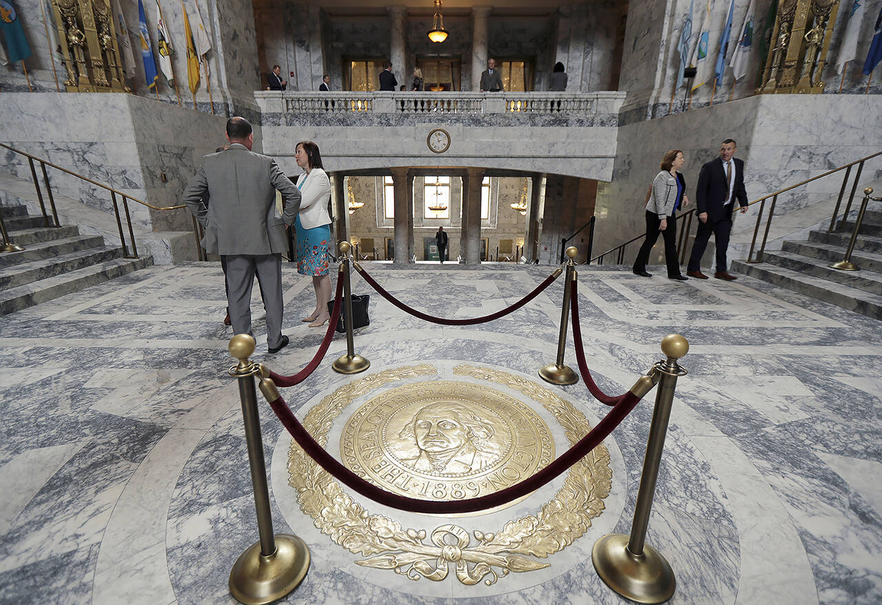 The Washington state seal protected by ropes in the rotunda of the Legislative Building at the Capitol in Olympia. (AP Photo/Ted S. Warren, File)