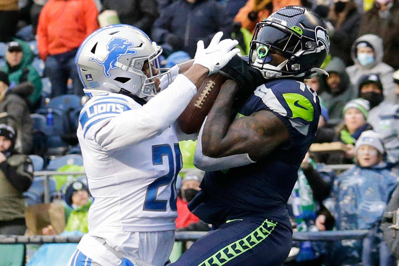 Seattle Seahawks wide receiver DK Metcalf, right, makes a catch for a touchdown in front of Detroit Lions cornerback Ifeatu Melifonwu, left, during the second half of an NFL football game, Sunday, Jan. 2, 2022, in Seattle. (AP Photo/John Froschauer)