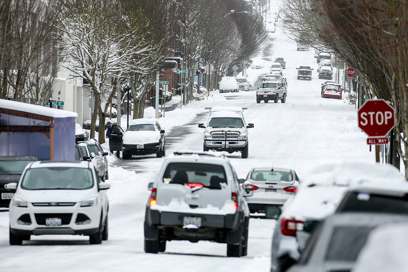 Inches of snow cover roads Saturday afternoon in downtown Edmonds, Washington on February 13, 2021.  (Kevin Clark / The Herald)