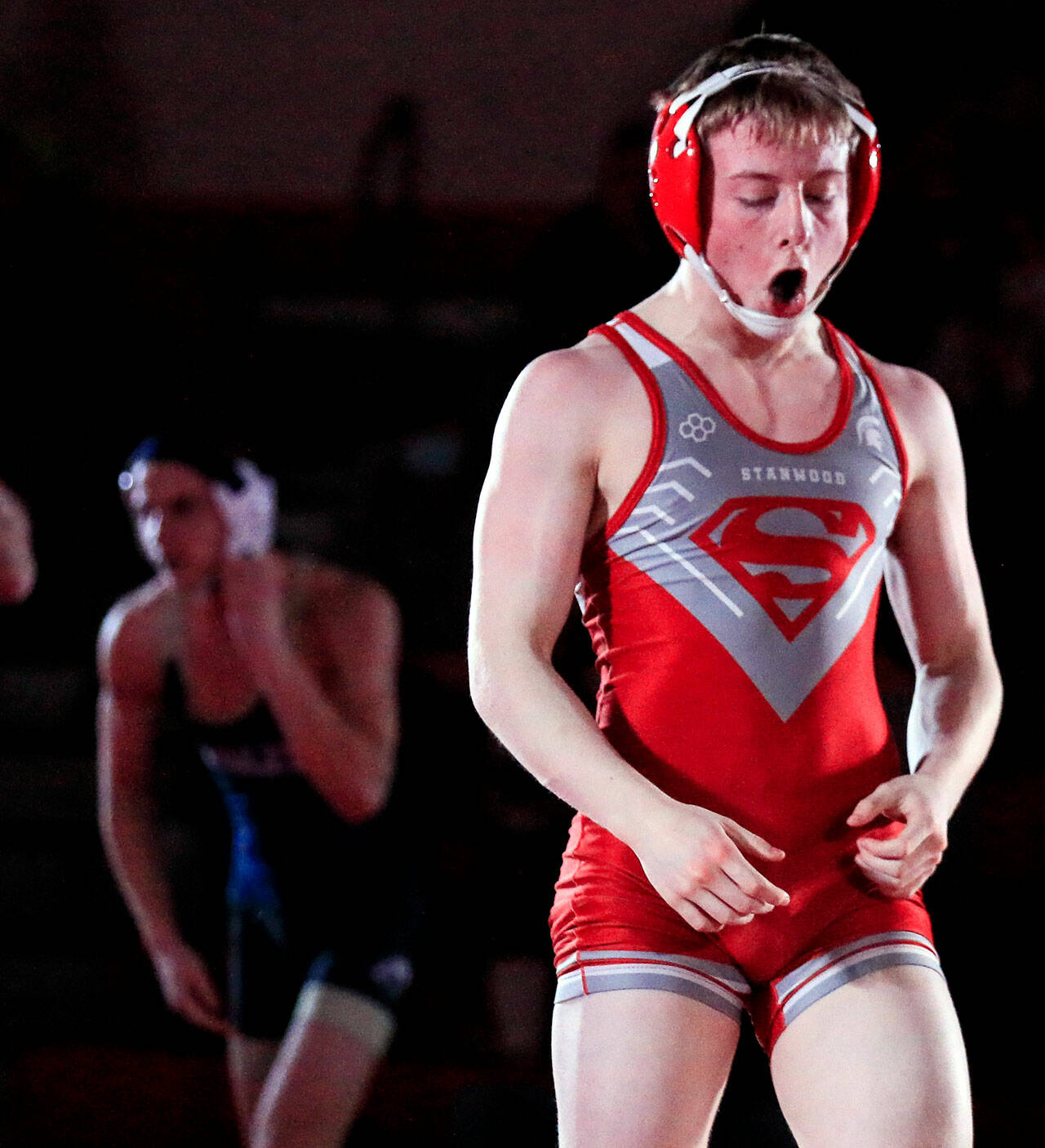 Stanwood’s Tyler Rhue celebrates his victory over Arlington’s Chase Deberry in the 126-pound weight class at Stanwood High School on Thursday evening. The Spartans defeated the Eagles 50-21. (Kevin Clark / The Herald)