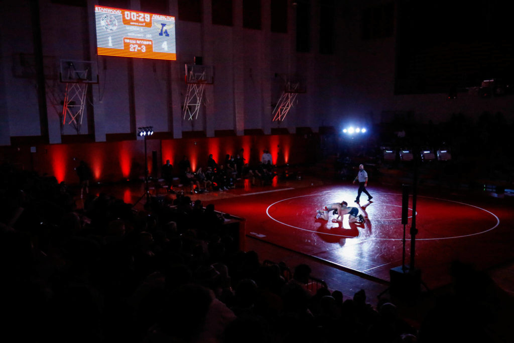 Stanwood’s Cruise Swanson wrestles Arlington’s RJ Gese in the 160-pound weight class at Stanwood High School on Thursday evening. (Kevin Clark / The Herald)
