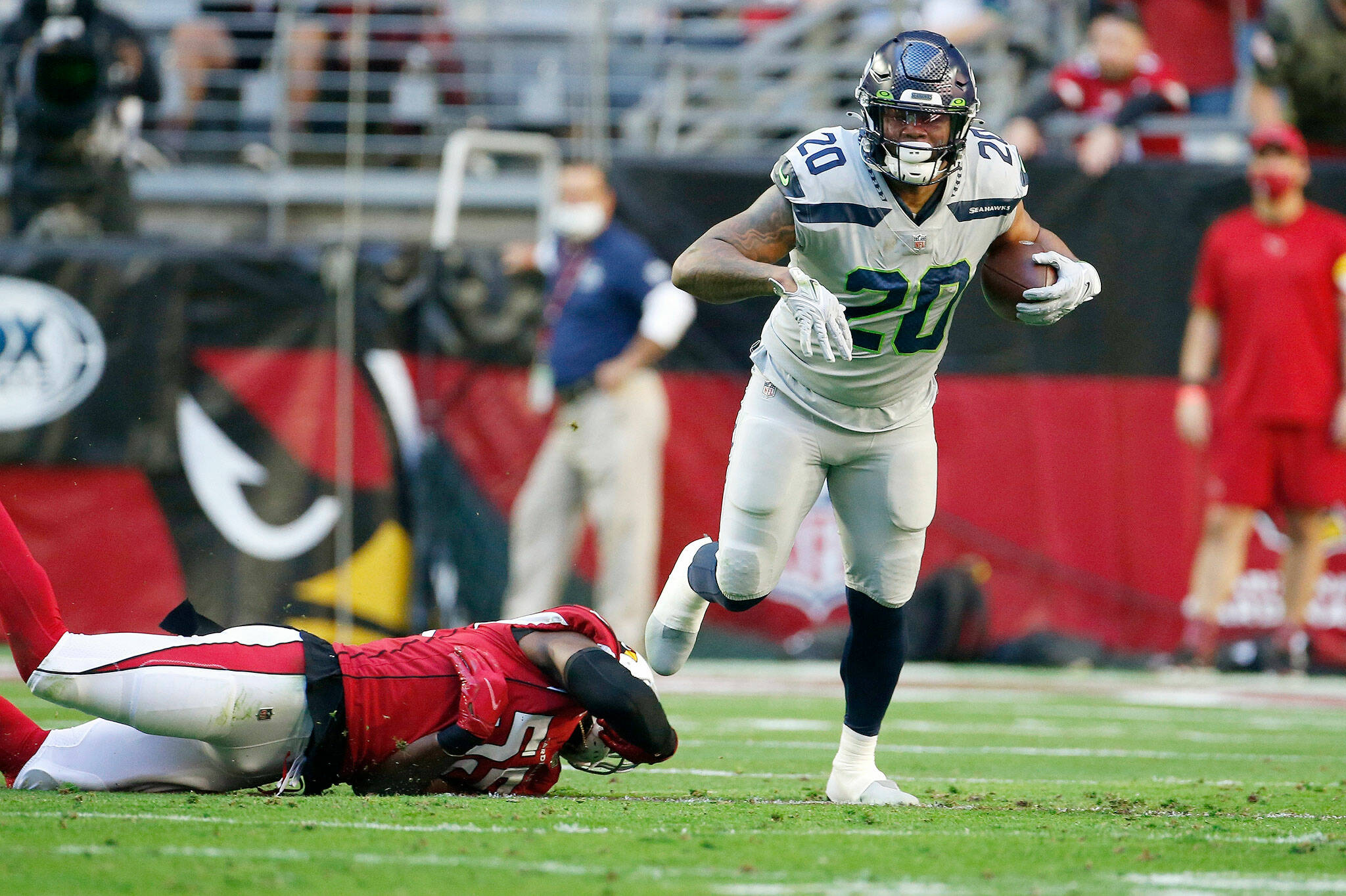 Seahawks running back Rashaad Penny (20) breaks a tackle against Cardinals linebacker Chandler Jones during the first half of a game Sunday in Glendale, Ariz. (AP Photo/Ralph Freso)