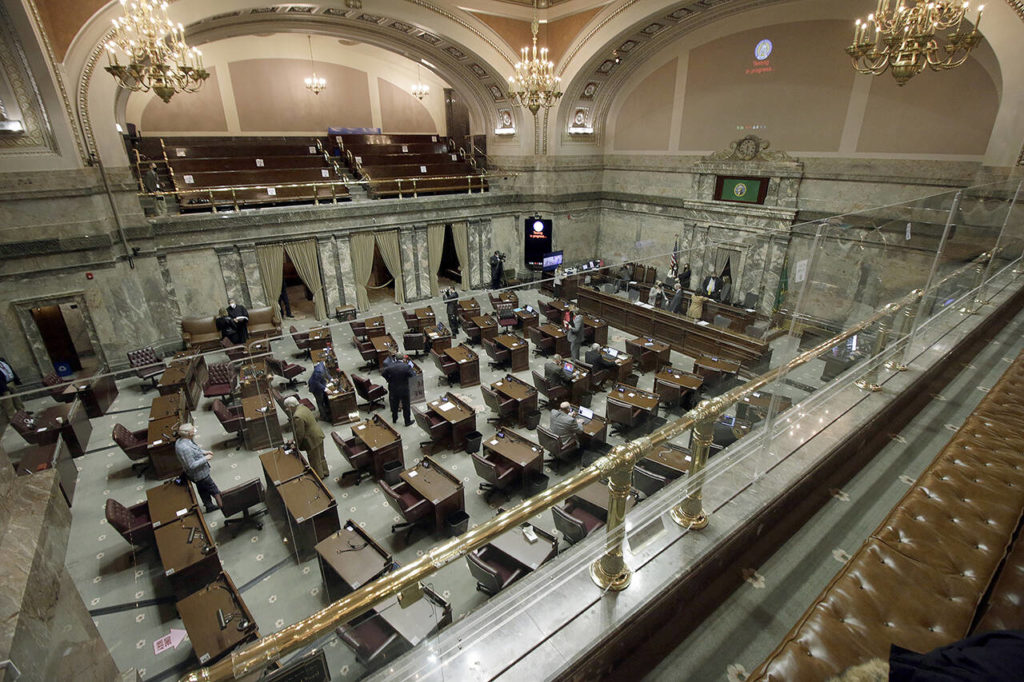 The Washington state Senate on the first day of the 60-day legislative session on Monday in Olympia. Due to the ongoing COVID-19 pandemic, a limited number of lawmakers are allowed on the chamber floor, with much of the Senate’s work being done in a hybrid remote fashion. (AP Photo/Rachel La Corte)
