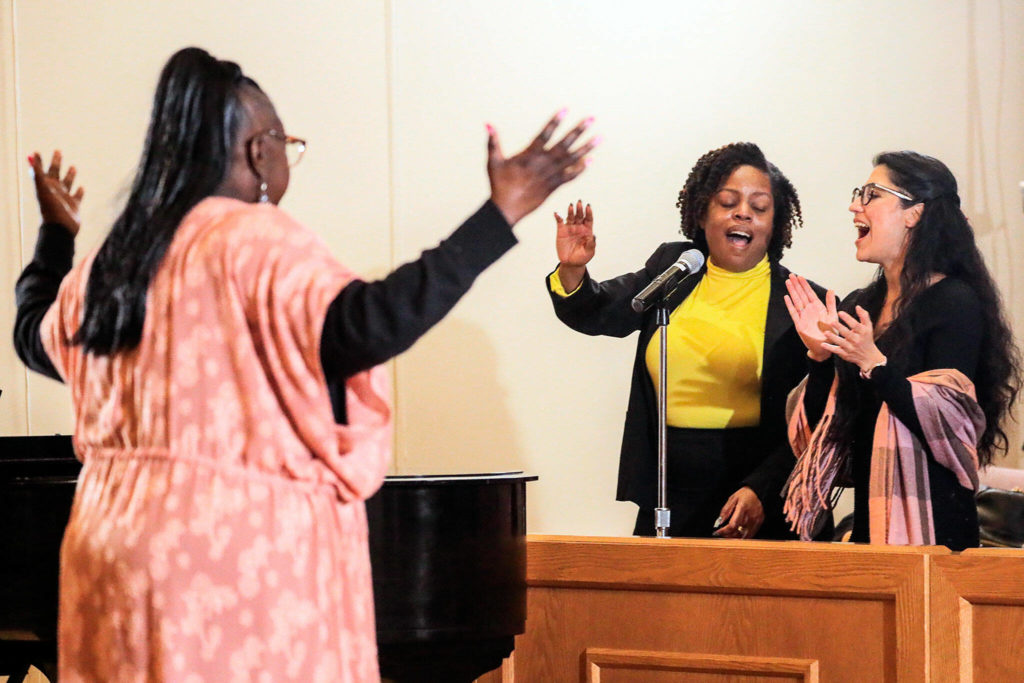 Holley Lacy (left) leads the MLK Celebration Ensemble with Sandra Wright (center) and Maria Caycedo on Sunday afternoon during the Greater Everett Area Rev. Dr. Martin Luther King, Jr. Community Celebration at the First Presbyterian Church of Everett. (Kevin Clark / The Herald)
