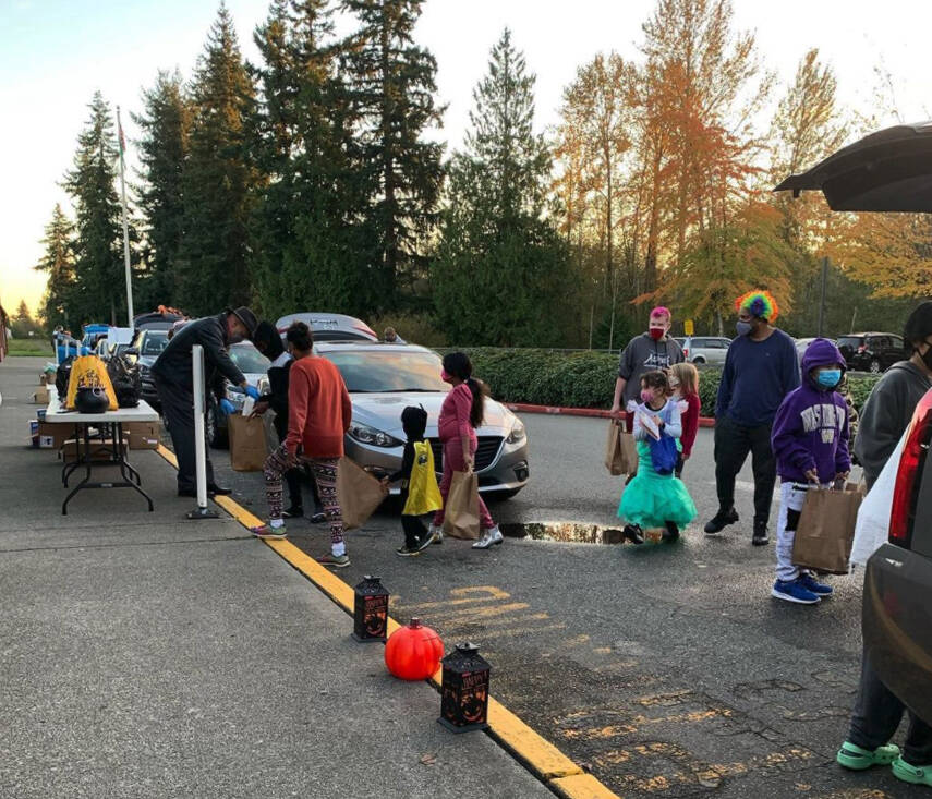 Tyrone McMorris, Executive Director of Casino Road Kids Ministries, and Carrie deKubber, owner of Bob’s Burgers and Brew - Everett, work together to serve local kids.