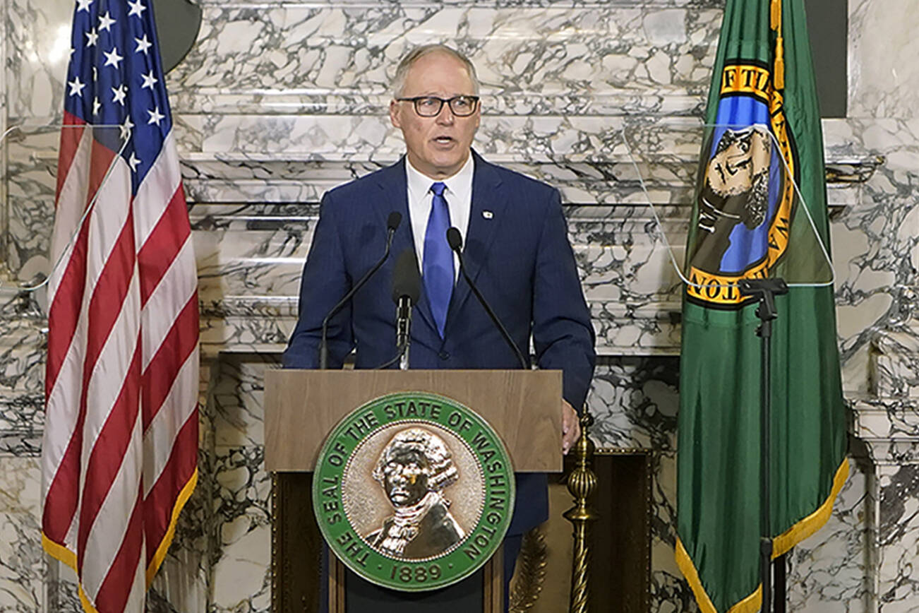 Washington Gov. Jay Inslee gives his annual State of the State address, Tuesday, Jan. 11, 2022, at the Capitol in Olympia, Wash. Due to cautions against COVID-19, Inslee gave his speech in the State Reception Room and it was shown by streaming video to lawmakers meeting remotely. (AP Photo/Ted S. Warren)