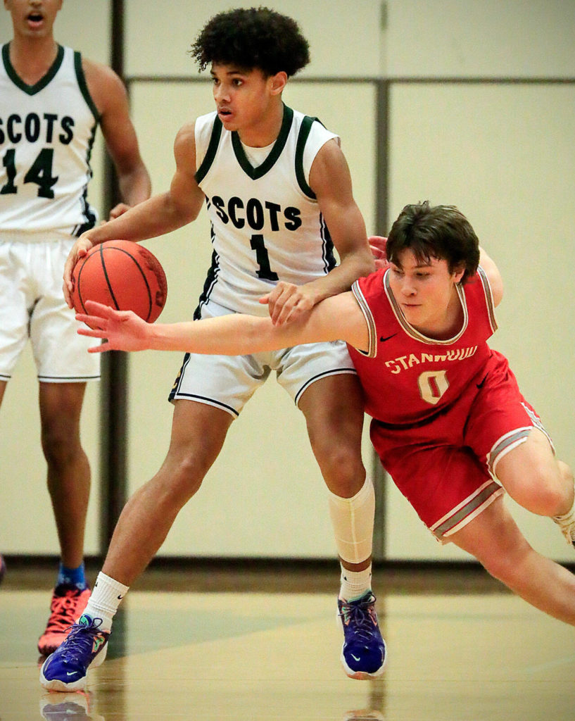 Stanwood’s Owen Thayer adds pressure to a shot attempt by Shorecrest’s Parker Baumann Thursday evening at Shorecrest High School in Shoreline, Washington on January 13, 2022. The Highlanders won 88-68. (Kevin Clark / The Herald)
