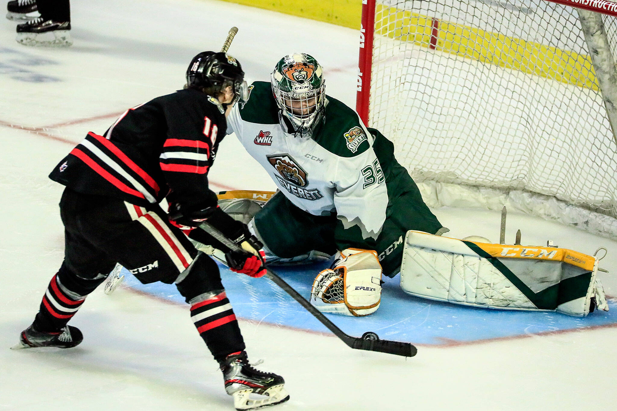 Portland’s Gabe Klaassen scores a goal past Everett’s Koen MacInnes during a game at the Angel of the Winds Arena on Jan. 1, 2022. (Kevin Clark / The Herald)