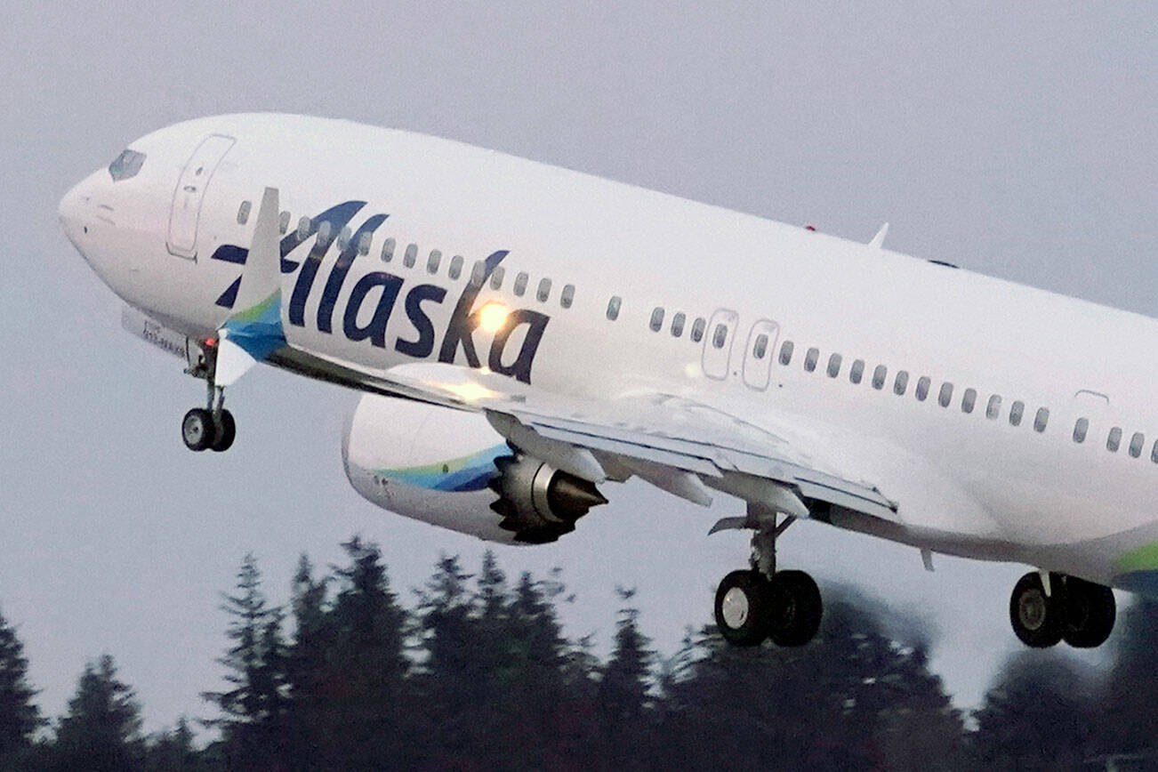 FILE - In this Monday, March 1, 2021 file photo, The first Alaska Airlines passenger flight on a Boeing 737-9 Max airplane takes off on a flight to San Diego from Seattle-Tacoma International Airport in Seattle. A Boeing pilot involved in testing the 737 Max jetliner was indicted Thursday, Oct. 14,2021 by a federal grand jury on charges of deceiving safety regulators who were evaluating the plane, which was later involved in two deadly crashes. (AP Photo/Ted S. Warren, File)