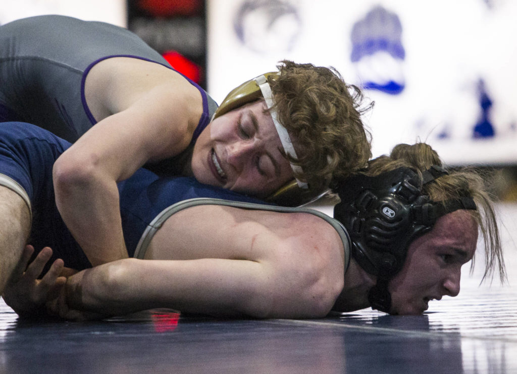 Lake Stevens’ Troy Valentine and Glacier Peak’s Chris Bergevin grimace while wrestling on Tuesday in Snohomish. (Olivia Vanni / The Herald)
