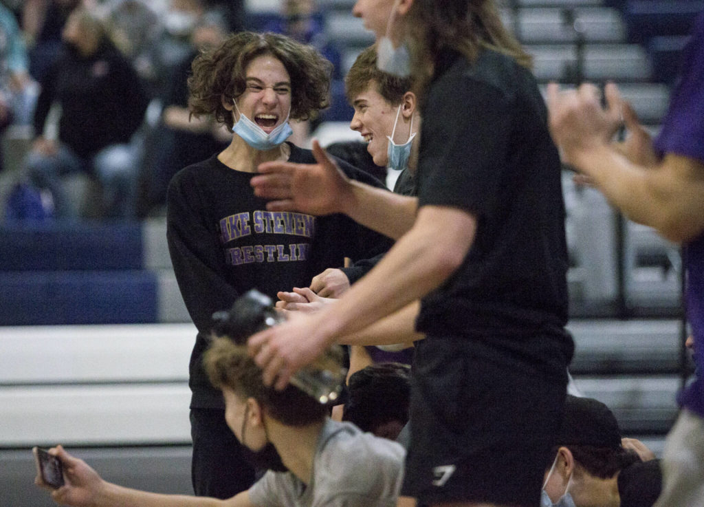 Lake Stevens wrestlers react to winning the match against Glacier Peak on Tuesday in Snohomish. (Olivia Vanni / The Herald)
