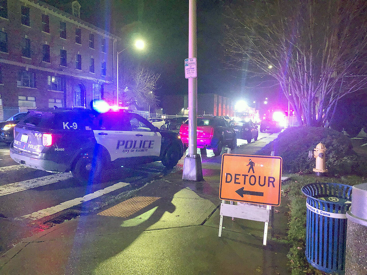 Police respond in downtown Everett after a man collapsed with a gunshot wound Nov. 27. He later died. (Caleb Hutton / Herald file)
