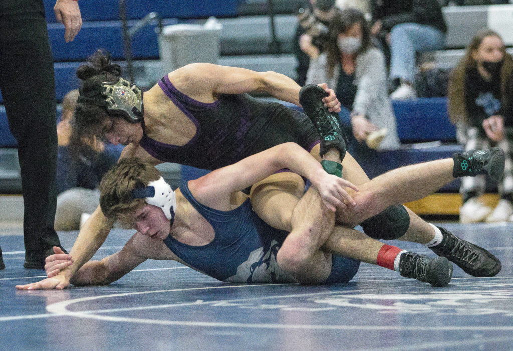 Glacier Peak’s Colin Gibbs and Lake Stevens’ Theron Tate wrestle during a match on Tuesday, Jan. 18, 2022 in Snohomish, Washington. (Olivia Vanni / The Herald)
