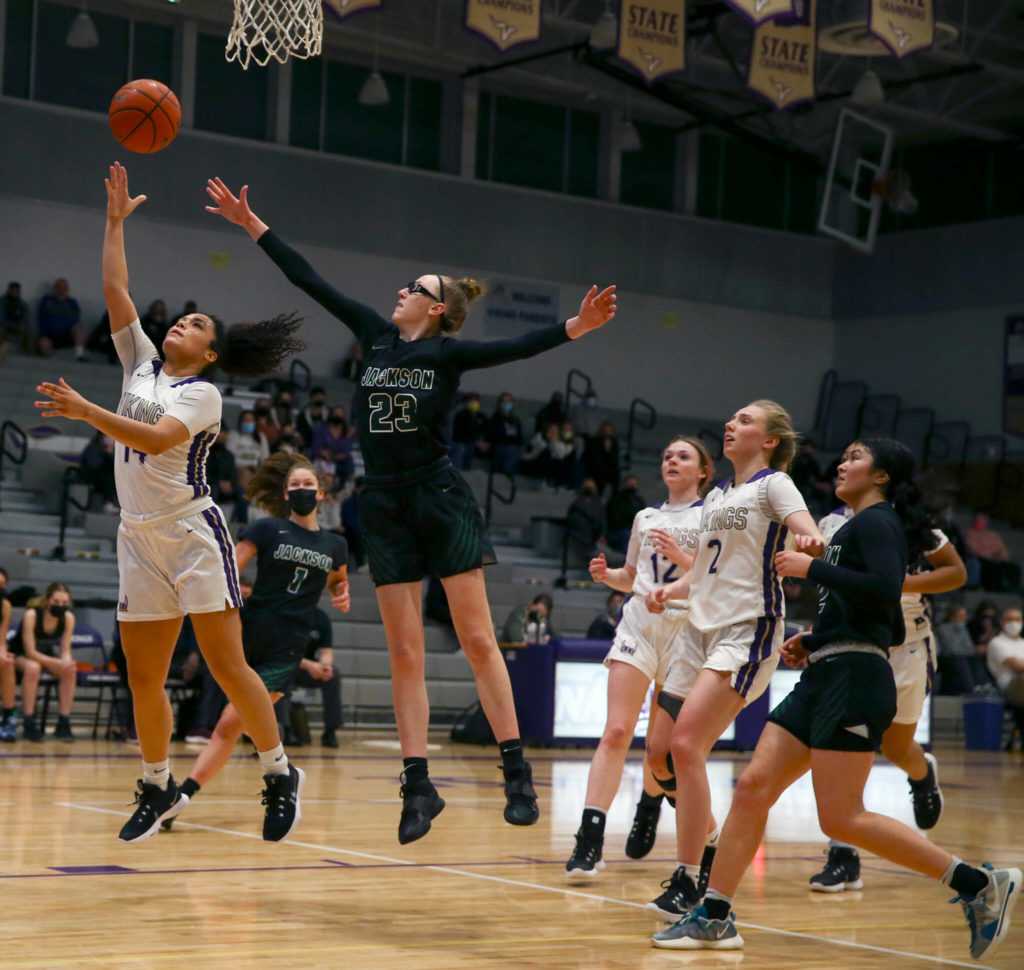 Lake Stevens’ Baylor Thomas attempts a layup past the outstretched arm of Jackson’s Hannah Mack on Saturday evening at Lake Stevens High School. (Kevin Clark / The Herald)
