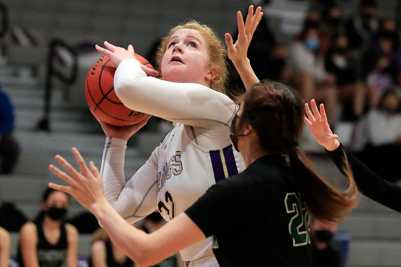 Lake Stevens' Cori Wilcox looks to shoot with Jackson's Arielle Leavens defending Saturday evening at Lake Stevens High School in Lake Stevens, Washington, January 22, 2022. (Kevin Clark / The Herald)