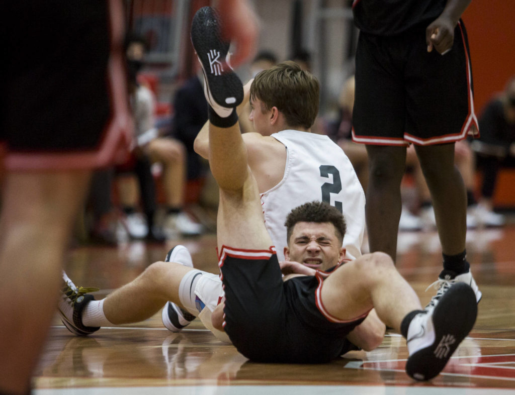Mountlake Terrace’s Chris Meegan grimaces after colliding with Stanwood’s John Floyd during Thursday’s game in Stanwood. (Olivia Vanni / The Herald)
