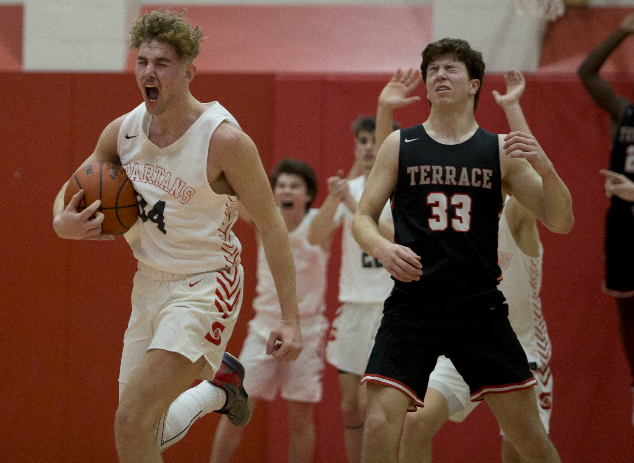 Stanwood’s Kaeden McGlothin yells after stealing the ball from Mountlake Terrace’s Adison Mattix to seal the win for Stanwood during Thursday’s game in Stanwood. (Olivia Vanni / The Herald)
