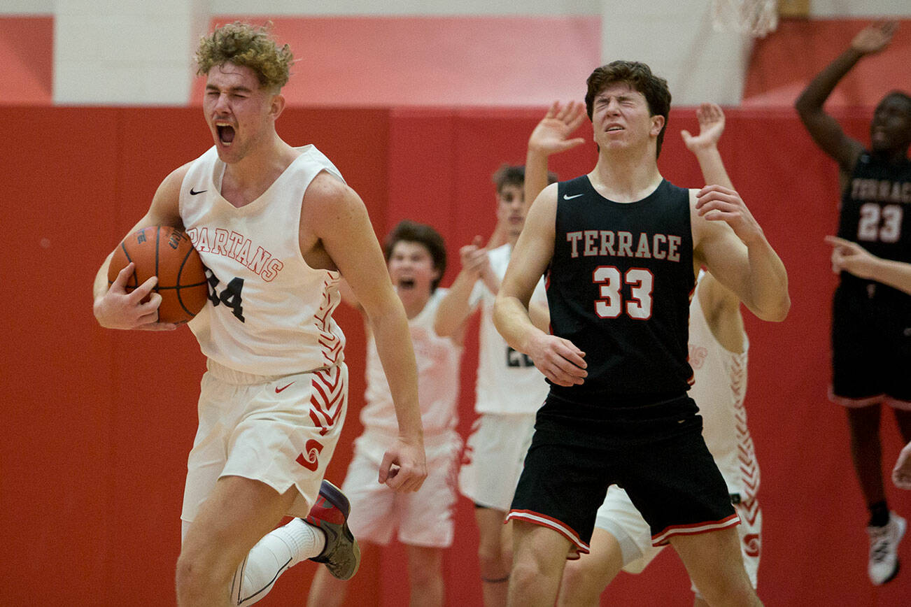 Stanwood's Kaeden McGlothin yells after stealing the ball from Mountlake Terrace's Adison Mattix to seal the win for Stanwood on Thursday, Jan. 20, 2022 in Stanwood, Washington. (Olivia Vanni / The Herald)