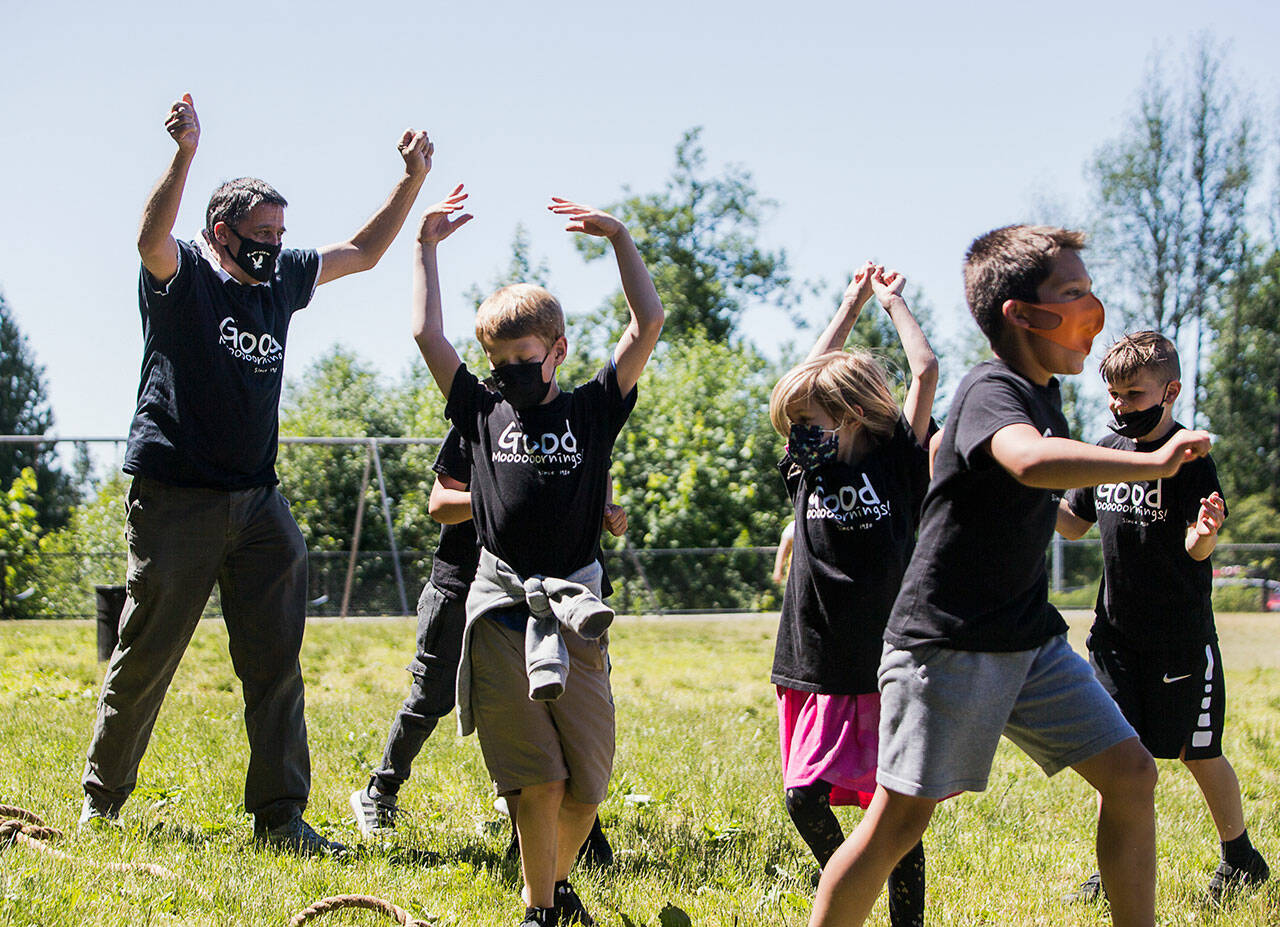 Jeff Thoreson cheers with his students after his class wins a tug-o-war game on June 17 as the end of the school year nears in Snohomish. (Olivia Vanni / Herald file photo)
