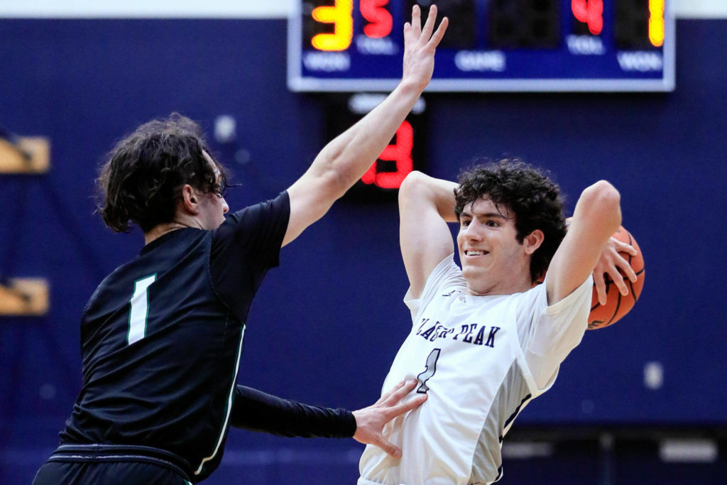 Jackson’s Drilon Veliu defends with Glacier Peak’s Aidan Davis looking to pass Friday evening at Glacier Peak High School in Snohomish, Washington on January 21, 2022. The Grizzles won 57-54. (Kevin Clark / The Herald)
