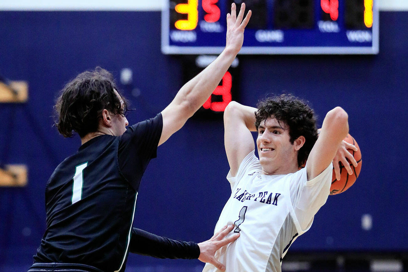 Jackson's Drilon Veliu defends with Glacier Peak's Aidan Davis looking to pass Friday evening at Glacier Peak High School in Snohomish, Washington on January 21, 2022. The Grizzles won 57-54. (Kevin Clark / The Herald)