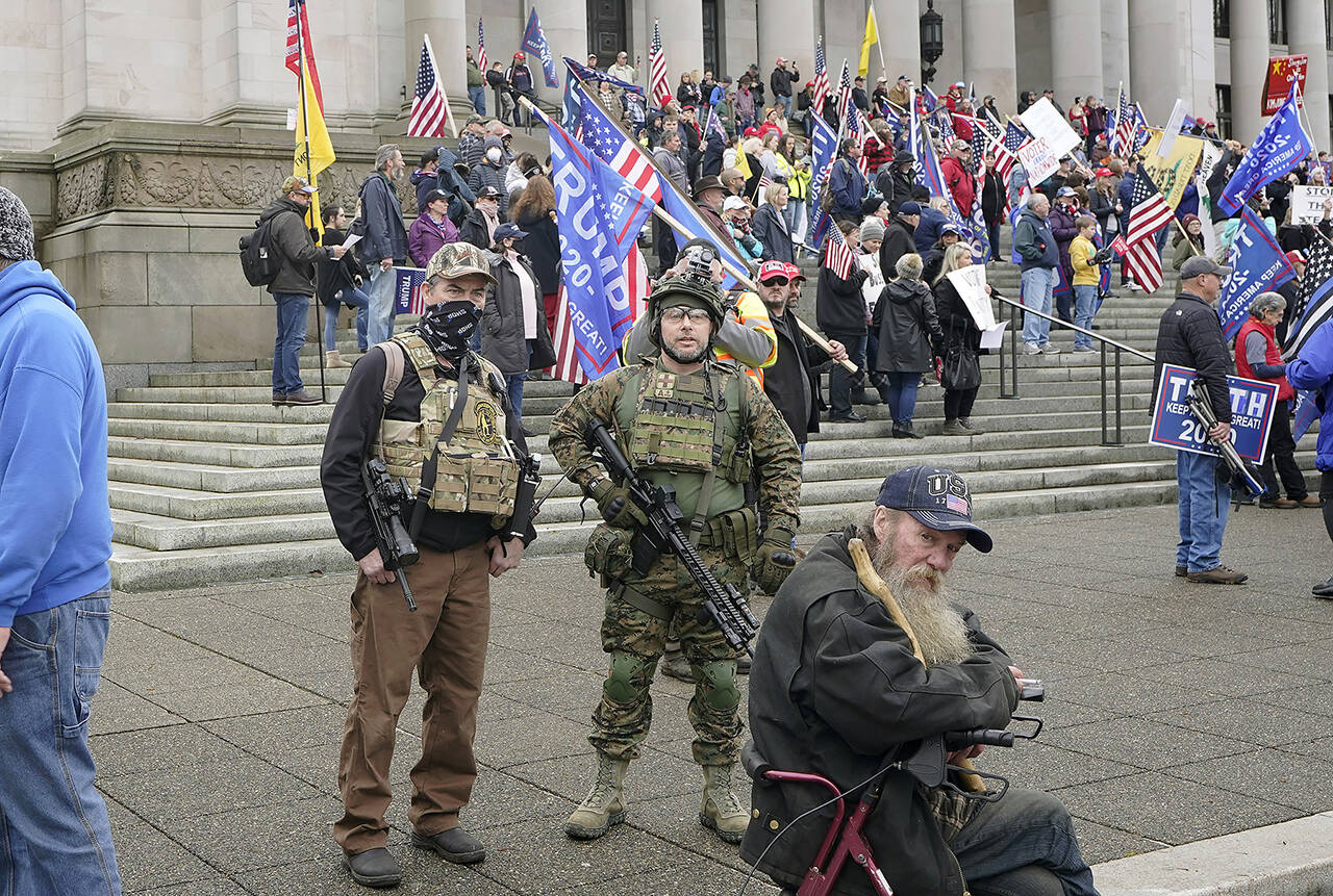 Two armed men at a protest supporting President Donald Trump on Jan. 6, 2021, at the Capitol in Olympia. (AP Photo/Ted S. Warren, File)
