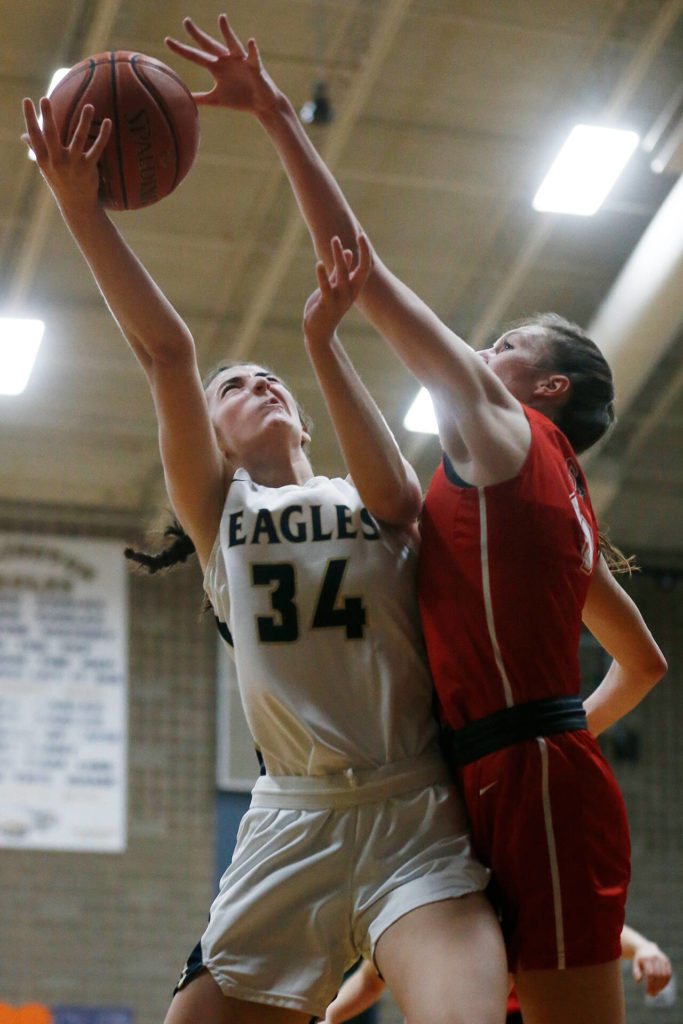 Arlington junior Jenna Villa (left) led the Eagles with 19 points. (Ryan Berry / The Herald)
